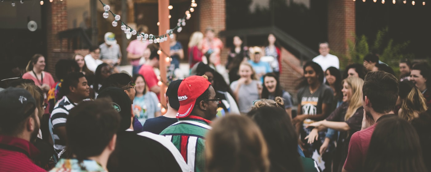 A crowd of people gathered at an informal community meetup.